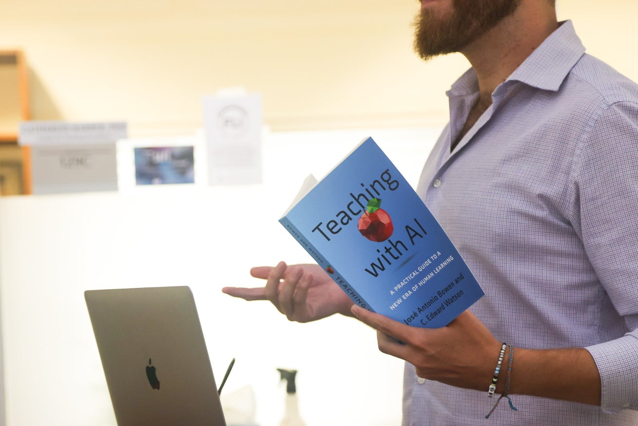 Faculty holding book