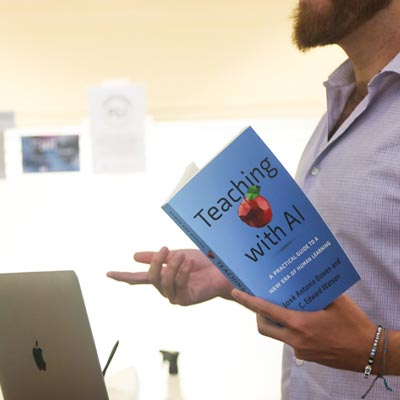 Faculty holding book